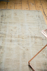 Close-up of vintage Oushak rug revealing worn knot heads and visible foundation.