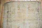 Distressed pile of vintage Oushak runner end, showing even wear, visible foundation, and blue marks.