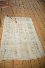 Distressed Oushak runner's bottom edge, showing neutral tones, even wear, and visible foundation.