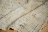 Underside of distressed Oushak rug runner, revealing foundation and blue processing marks.