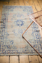 Distressed Oushak runner, faded blush and navy blue vinery with mostly even wear.
