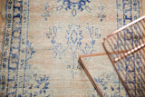 Decorative distressed texture of a vintage Oushak rug, pale blush and navy patterns.