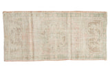 Distressed vintage Oushak runner with faded roundel medallion, pale pink, seafoam, ivory shades.