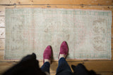 Distressed vintage Oushak runner, full view, with even wear revealing pale pink, seafoam, ivory.