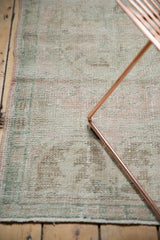 Distressed Oushak rug runner pile with even wear, visible foundation, and soft pink, seafoam tones.