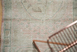 Evenly worn distressed Oushak rug surface with visible foundation and soft pastel tones.