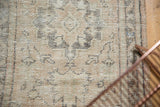 Vintage Distressed Oushak runner's textural pile, showing faded pale charcoal motifs on sand beige.