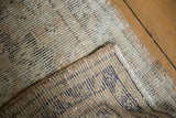 Vintage distressed Oushak rug detail: worn knot heads, visible foundation, secured edge.