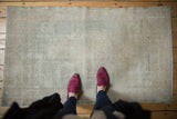 Distressed Oushak runner showing visible wear across knot heads and foundation.