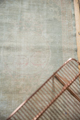 Distressed Oushak runner's texture highlighting wear to knot heads in dusty seafoam.