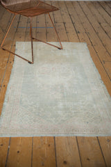 Distressed vintage Oushak runner, displaying faded dusty seafoam colors and worn texture.