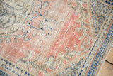 Distressed pile of vintage Oushak rug showing faded pale dusty rose and cobalt blue.
