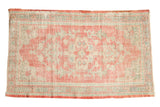 Vintage Distressed Oushak rug with a faded blush medallion, ivory field, and seafoam green accents, 2'9