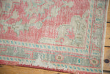 Distressed Turkish Oushak rug corner with secured side, even wear, raspberry, ivory, mint green.