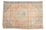 Distressed Oushak rug, faded rose and ivory tones, cobalt blue medallion, geometric border, 2'10