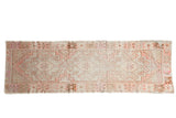 Distressed vintage Oushak runner, faded triple medallion and geometric border in blush, brown, ivory.