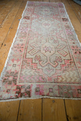 Distressed Oushak runner detail, blush, brown, and silver geometric motifs with visible foundation.