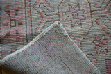 Vintage Distressed Oushak runner, lifted corner showing secured edge and foundation through wear.