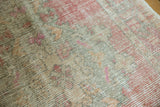 Worn pile texture of vintage Oushak runner, revealing faded rose, ivory, and pale sea-foam green.