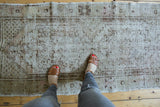 Vintage Distressed Oushak rug runner with even wear, faded ivory, beige, and brown patterns.