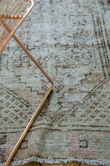 Distressed Oushak runner showing faded ivory, beige, brown patterns, even wear, and fringe.