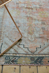 Vintage Distressed Oushak runner's geometric border and faded pile with pale apricot and sage tones.