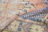 Distressed Oushak rug pile with visible knot heads, featuring stepped geometric and floral motifs.