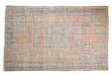 Vintage distressed Oushak rug with faded apricot orange field, roundel medallion, floral vinery, 6'2