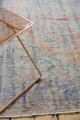 Distressed Oushak rug texture with even wear, pale apricot, faded blue, and mint green.