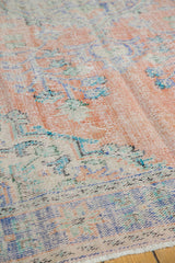 Vintage distressed Oushak rug texture, showing even wear across knot heads in apricot, blue, ivory.