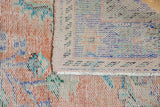 Reverse foundation and knot heads with distressed apricot, blue pile of vintage Oushak carpet.