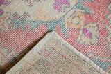 Hand-knotted Turkish Oushak runner with distressed faded red rose pile and sturdy reverse.