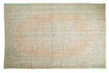 Distressed Vintage Oushak carpet with a muted starburst medallion and faded beige, mint green hues. 6'4