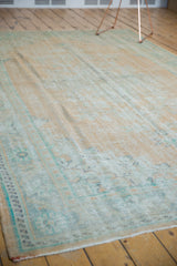 Vintage distressed Oushak rug with even wear, featuring soft beige and mint green pile.