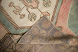 Distressed vintage Oushak runner's folded corner, revealing spider pattern, blush pile, hand-knotted foundation.
