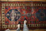 Antique Northwest Persian runner's cherry red field, navy geometric pattern, beige border, and low pile.