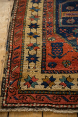 Antique Northwest Persian runner corner detail: star borders, cherry red field, low pile.
