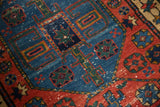 Northwest Persian rug's cherry red and blue geometric floral cross sections and low pile.