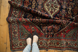 Engelas rug's rich navy blue, brick red, and green Herati field patterns and fringe.