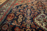 Close-up of Engelas rug's Herati pattern with navy, brick red, and oxidized green pile.