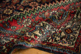 Close-up of vintage Engelas rug's thick Herati field, brick red, navy blue, oxidized green.