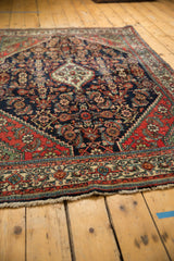 Secured fringe and intricate border patterns with navy, brick red on Engelas rug.