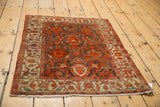 Angled view of the antique Persian Malayer rug, displaying its even low pile and texture.