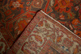 Corner detail of an antique Malayer fragment showing its hand-knotted back and low pile.