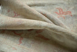 Textured pile of a vintage distressed Oushak rug, showing subtle faded terra cotta patterns.