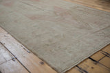 Vintage distressed Oushak runner showing its soft blush, beige tones and worn texture.