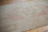 Distressed Oushak runner close-up showcasing stepped spandrel motif, pale blush, sand, and silver.