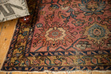 Antique Lilihan rug corner: raspberry red field, intricate borders, and secured fringe.