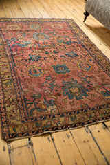 Persian Lilihan antique rug border, tattered edge, dusty gold and deep blue motifs.