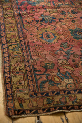 Antique Persian Lilihan rug with detailed dusty gold border, raspberry field, and secured tattered side.